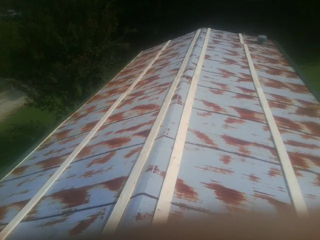 Rusted metal roof panels with new wood purlins before replacement — Storm Damage Roof Repair in Anamoose by Roofing Brothers