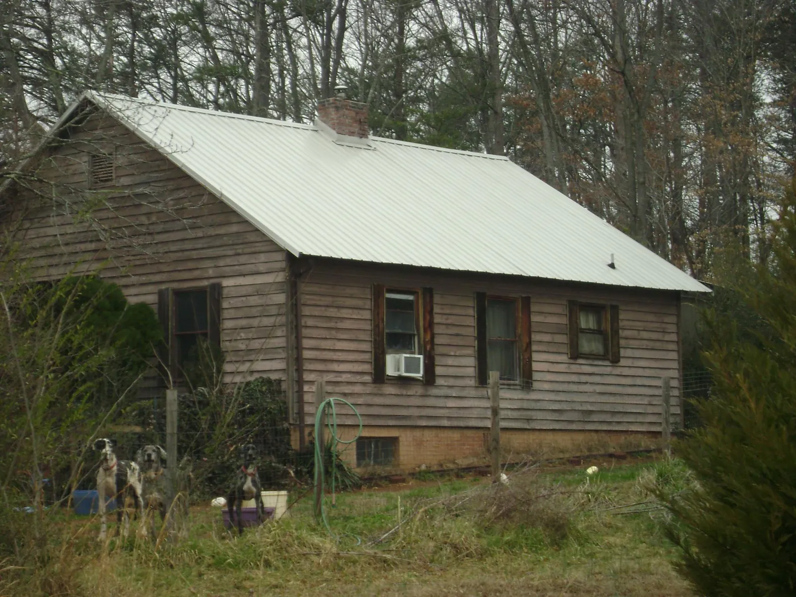 White metal roof on an old wood sided farmhouse, from a Metal Roof Installation job in Anamoose